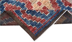 A hand-knotted Afghan Yekta rug featuring a geometric pattern in blue, red, and cream wool.