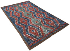 An Afghan Yekta rug featuring a bold geometric pattern in red, blue, and teal on a dark border.