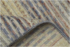 A handmade Afghan Yekta rug featuring a textured, striped pattern in muted earth tones.
