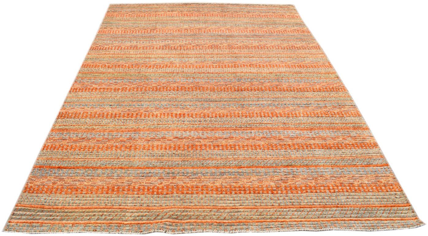 Handmade Afghan Yekta rug featuring a textured, striped pattern in shades of orange and grey.