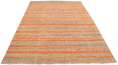 Handmade Afghan Yekta rug featuring a textured, striped pattern in shades of orange and grey.