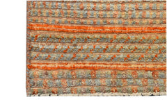 Handmade Afghan Yekta rug featuring a textured, striped pattern in shades of orange and grey.
