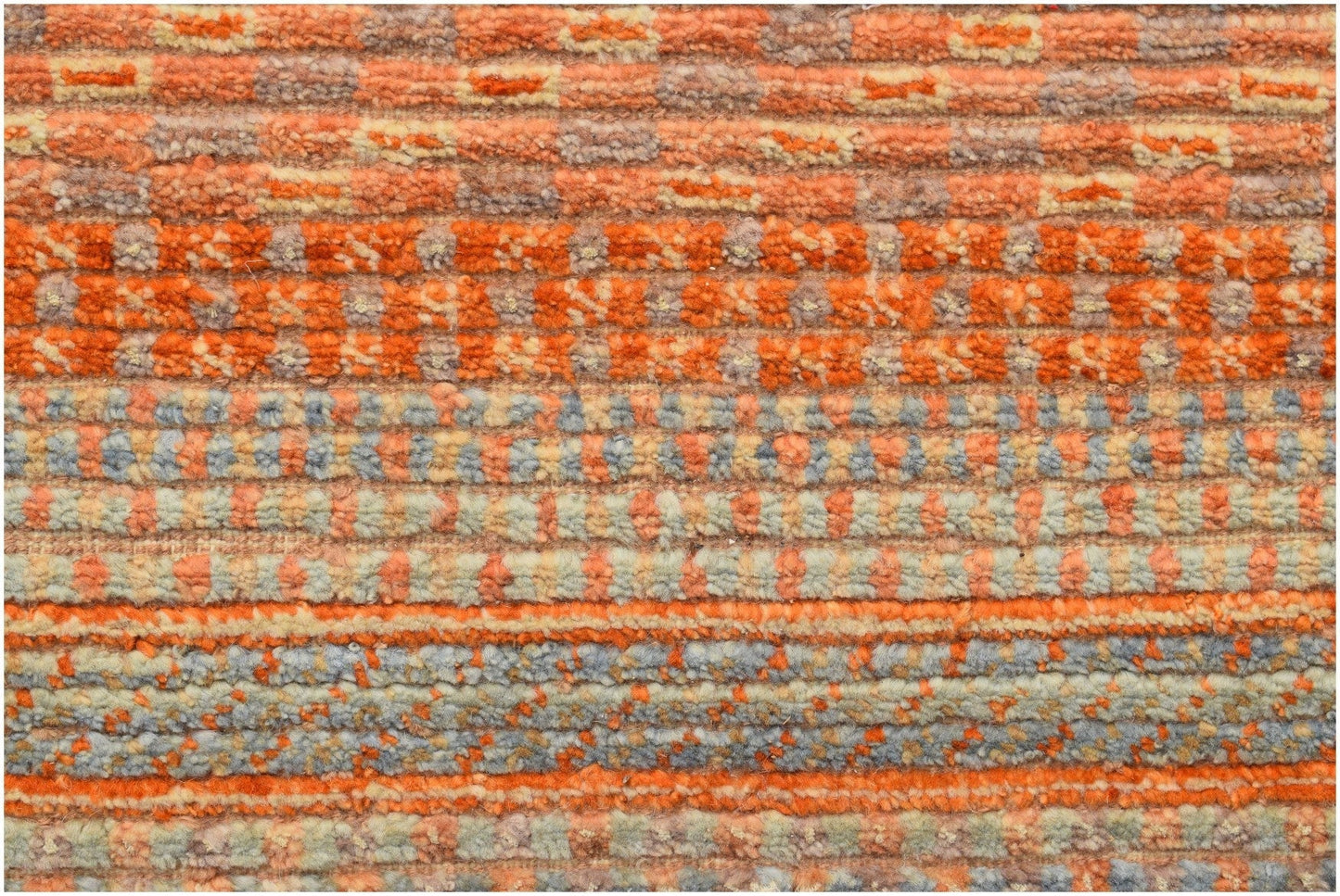 A handmade Afghan Yekta rug featuring a textured, horizontal striped pattern in orange and grey.