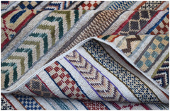 A handmade Afghan Yekta rug featuring a textured pattern of colorful geometric stripes.