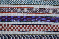 A handmade Afghan Yekta rug featuring horizontal bands of colorful geometric and checkered patterns.