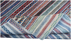 An Afghan Yekta rug featuring a folded corner and a vibrant, multi-colored striped geometric pattern.