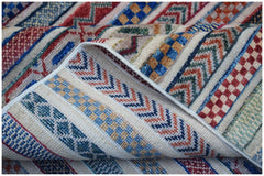 A handmade Afghan Yekta rug featuring a textured pattern of colorful geometric stripes.