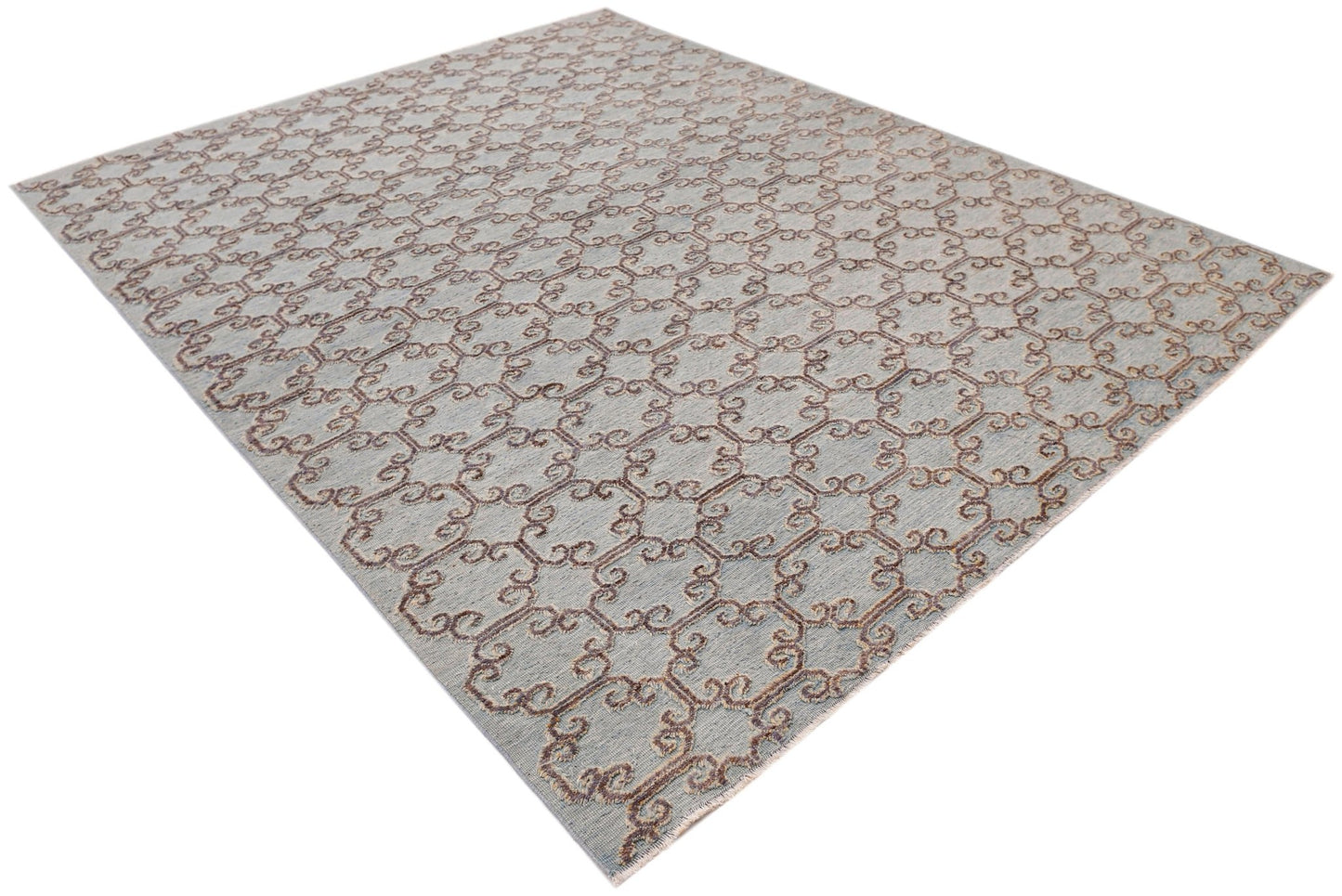An Afghan Yekta rug featuring a light blue background with a repeating brown scrollwork pattern.