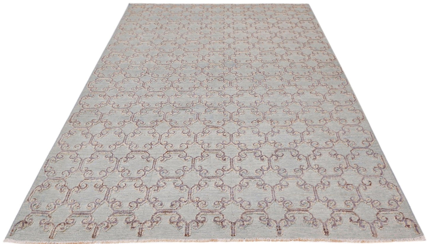 An Afghan Yekta rug featuring a light blue background with a repeating purple geometric pattern.