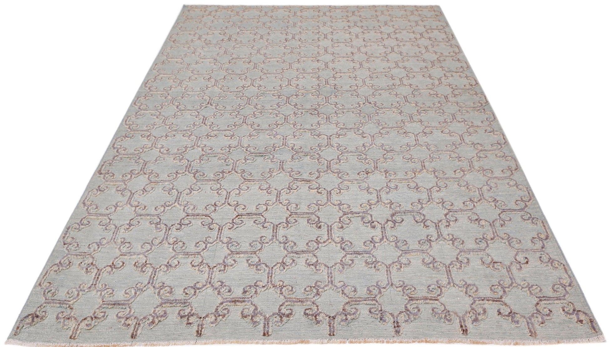 An Afghan Yekta rug featuring a light blue background with a repeating purple geometric pattern.