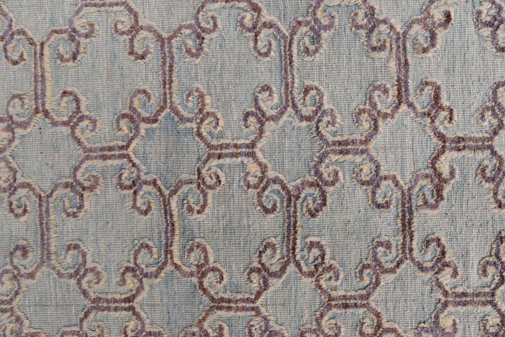 An Afghan Yekta rug featuring a textured, light blue geometric pattern with raised purple details.