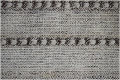 A handmade Afghan Yekta rug featuring a textured pattern of alternating cream and brown wool stripes.