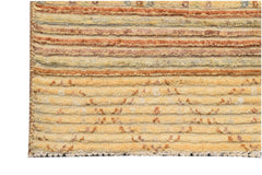 A handmade Afghan Yekta rug featuring horizontal stripes in shades of yellow, orange, and brown.