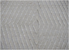 A handmade Afghan Yekta rug featuring a textured, cream-colored diamond pattern.