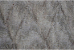 A close-up view of a handmade Afghan Yekta rug featuring a textured, neutral-toned wool weave.