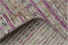 A handmade Afghan Yekta rug featuring a textured blend of purple and neutral striped patterns.