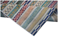 Handmade Afghan runner rug featuring a textured striped pattern in vibrant, multi-colored wool.