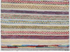 Handmade Afghan runner rug featuring horizontal bands of colorful geometric and chevron patterns.