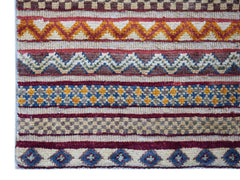 Handmade Afghan Yekta runner rug featuring horizontal bands of geometric and tribal patterns.