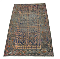 An antique Afghan Balouch rug featuring geometric patterns in muted orange, grey, and blue tones.
