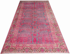 An antique handwoven Chinese Khotan rug featuring an intricate pomegranate pattern in vibrant pink.