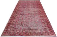 An antique handwoven Khotan rug featuring an intricate pomegranate pattern in vibrant pink.