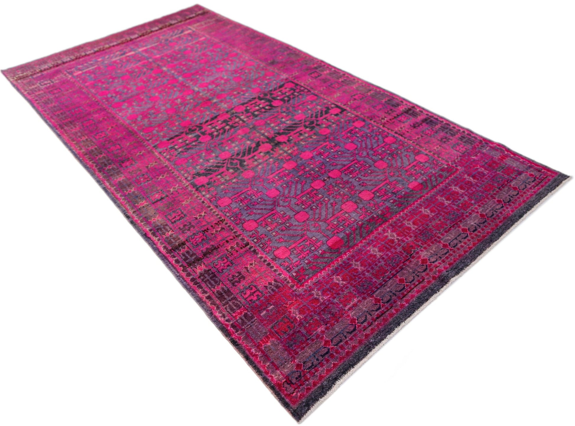 An antique handwoven Khotan rug featuring an intricate pomegranate pattern in vibrant pink.