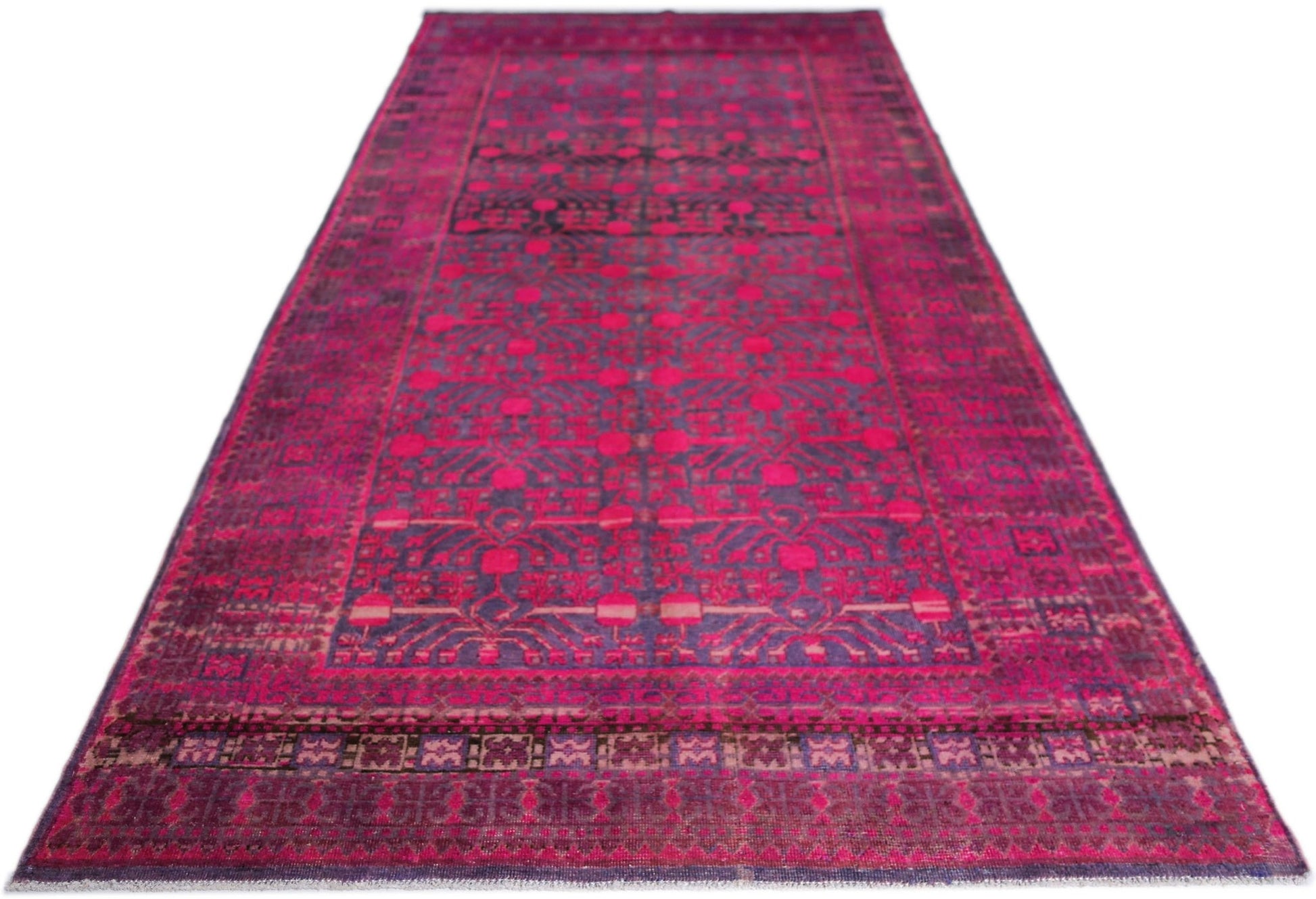 An antique handwoven Khotan rug featuring an intricate pomegranate pattern in vibrant pink.