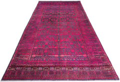 An antique handwoven Khotan rug featuring an intricate pomegranate pattern in vibrant pink.