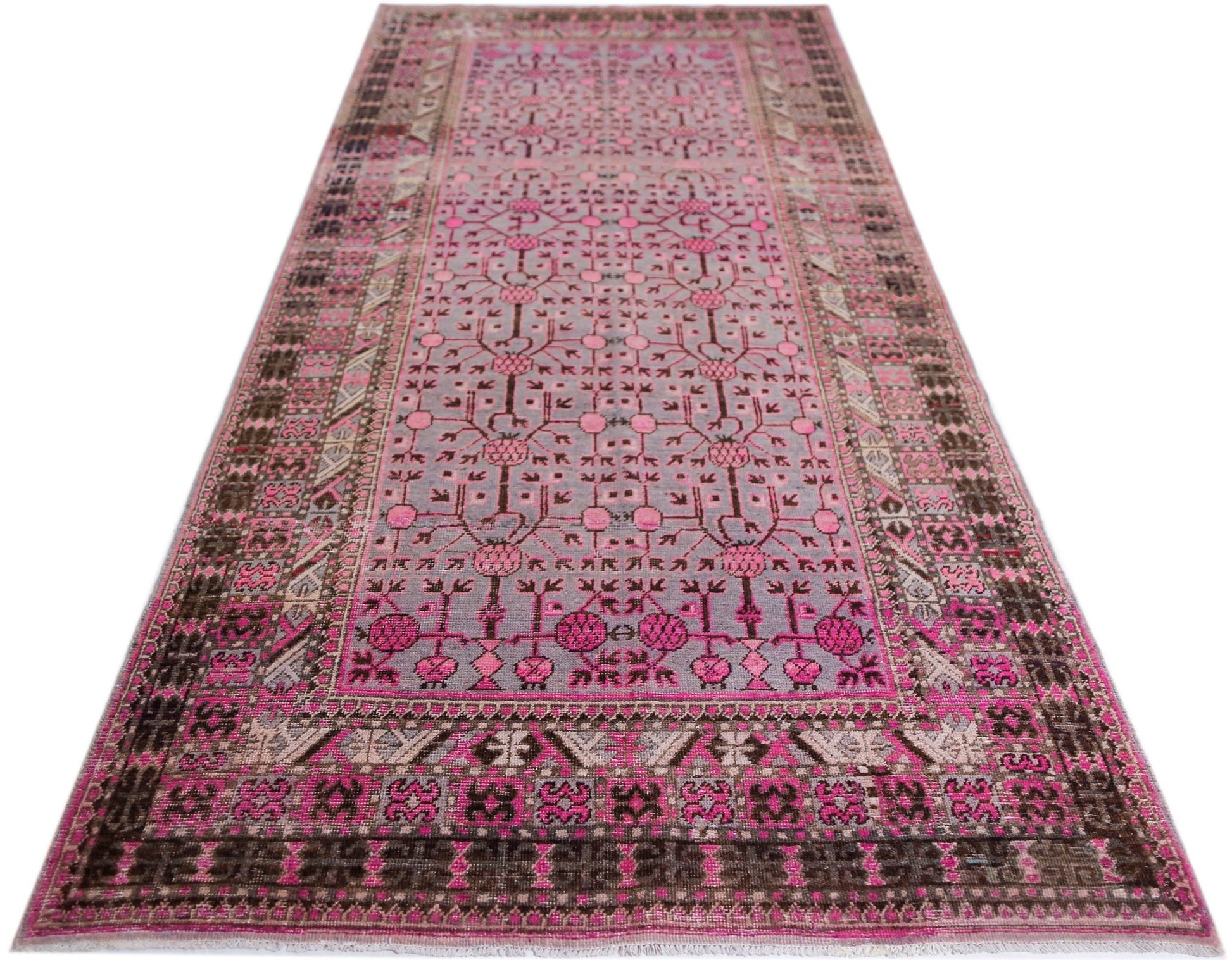 An antique handwoven Chinese Khotan rug featuring a pink pomegranate pattern on a grey field.