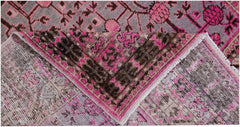 An antique handwoven Khotan rug featuring an intricate pomegranate pattern in vibrant pink tones.