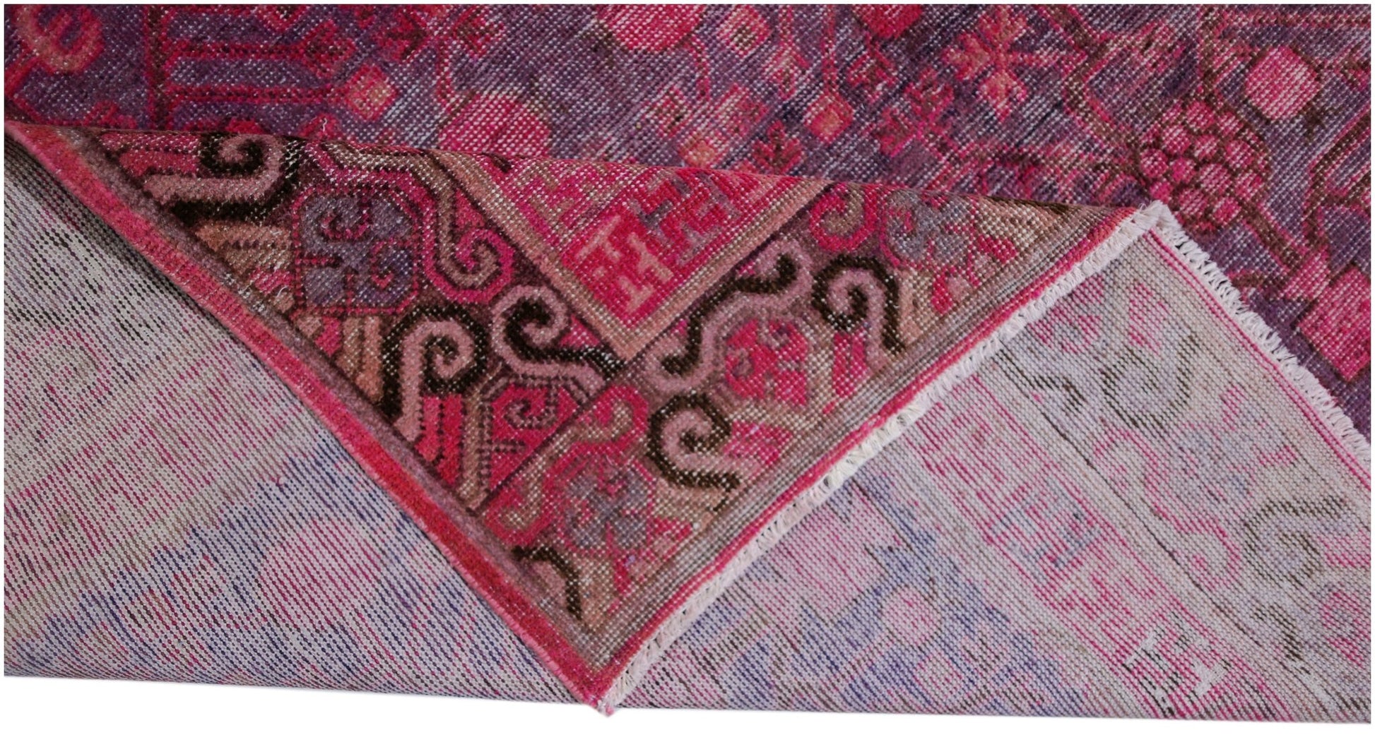 An antique handwoven Khotan rug featuring an intricate pomegranate pattern in vibrant pink.