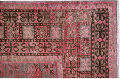 An antique handwoven Khotan rug featuring an intricate pomegranate pattern in shades of pink.