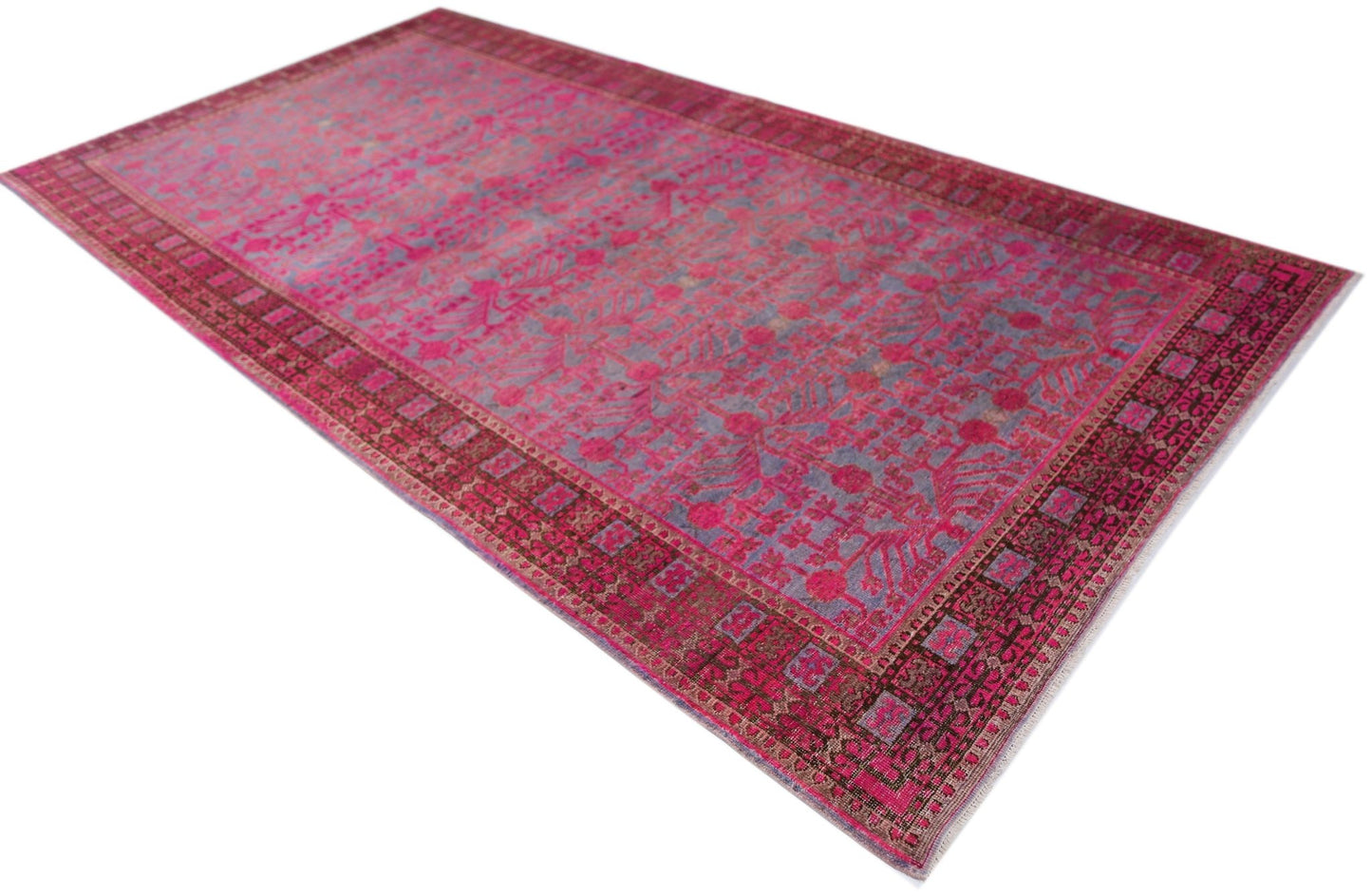 An antique handwoven Chinese Khotan rug featuring an intricate pomegranate pattern in vibrant pink.