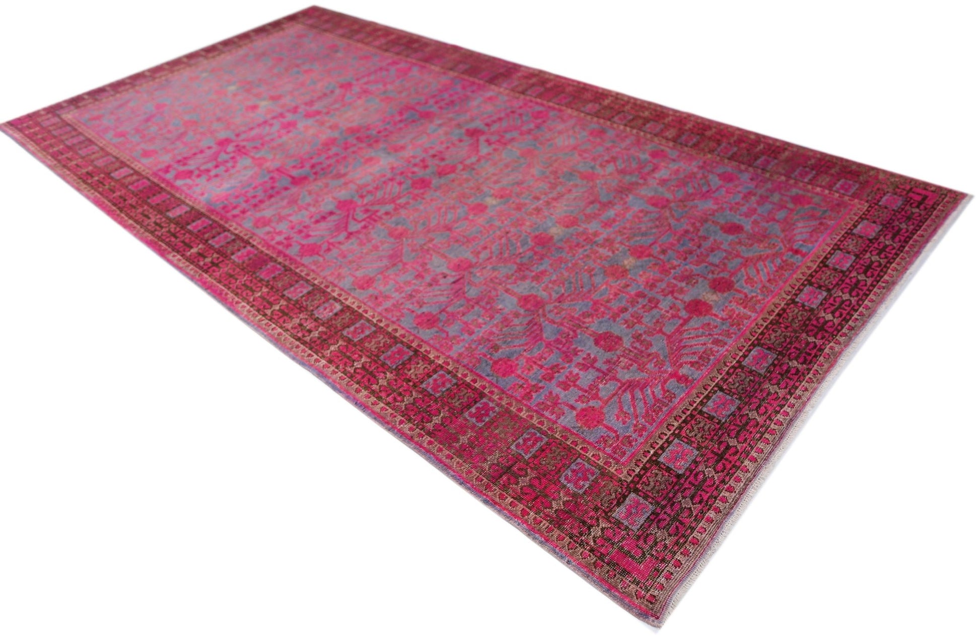 An antique handwoven Chinese Khotan rug featuring an intricate pomegranate pattern in vibrant pink.