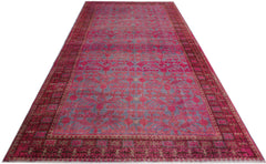 An antique handwoven Chinese Khotan rug featuring an intricate pomegranate pattern in vibrant pink.