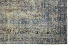 An antique Persian Kerman rug featuring a faded blue and cream floral medallion pattern.