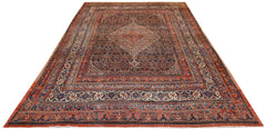An antique Persian Senneh rug featuring a central medallion on a dark floral field.