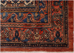 An antique Persian Senneh rug featuring intricate floral patterns in red, blue, and cream tones.