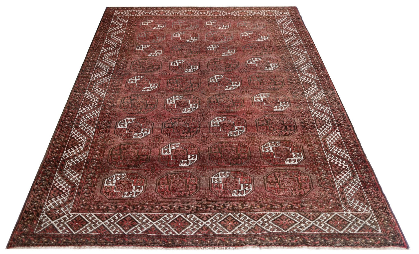 An antique Afghan Turkmen rug featuring repeating elephant foot motifs in deep red wool.