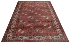 An antique Afghan Turkmen rug featuring repeating elephant foot motifs in deep red wool.