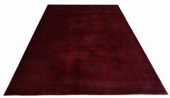 An antique Afghan Turkmen rug featuring a deep red field with repeating blue elephant foot motifs.