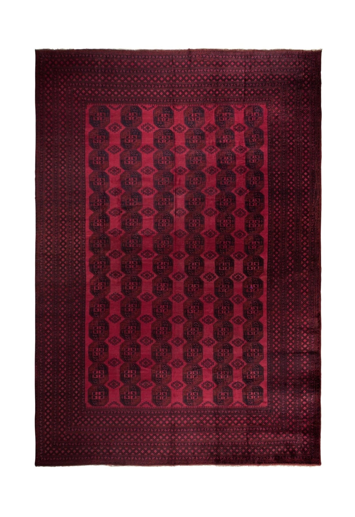 An antique Afghan Turkmen rug featuring a repeating geometric octagonal pattern in deep red.