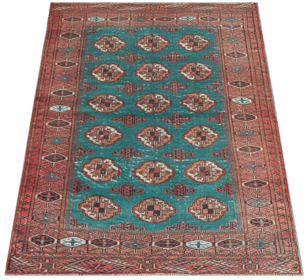 A vintage handwoven Afghan Turkmen rug featuring repeating geometric medallions on a teal field.