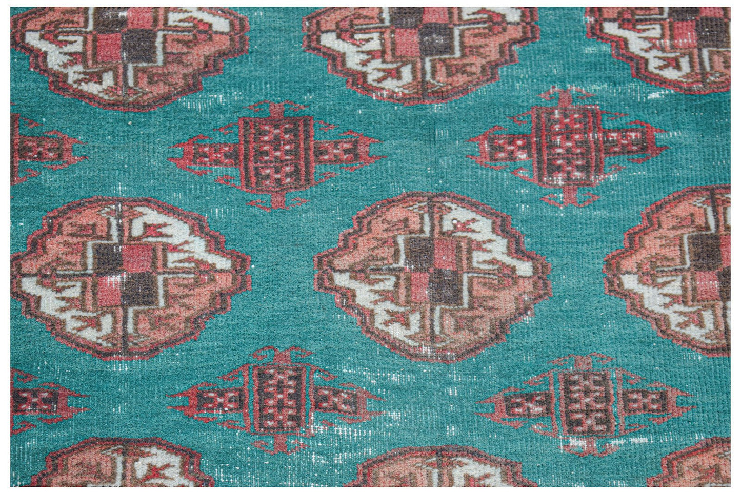 Vintage Afghan Turkmen rug with a teal background and repeating geometric patterns.