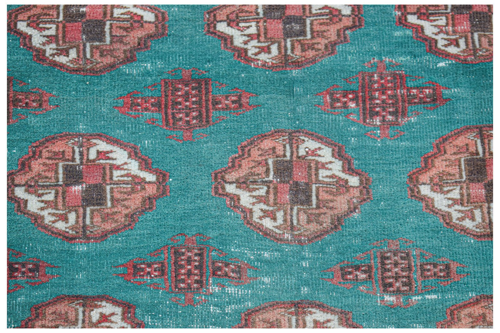 Vintage Afghan Turkmen rug with a teal background and repeating geometric patterns.