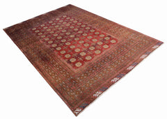 An antique Afghan Turkmen rug featuring a deep red field with repeating geometric gul motifs.