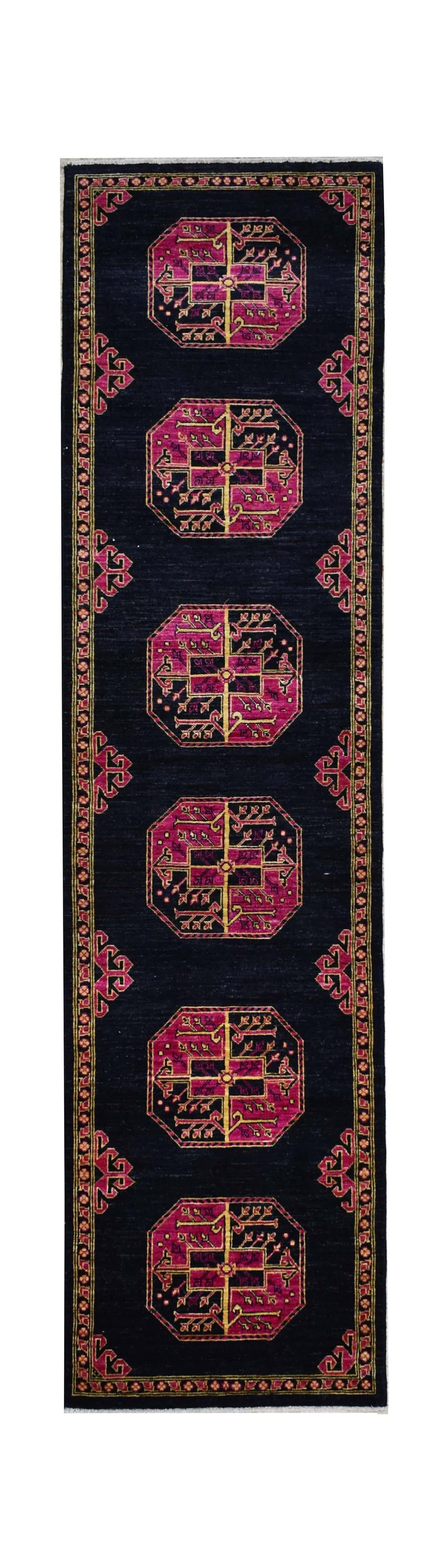 A handmade Afghan Chobi runner featuring six magenta octagonal medallions on a dark navy field.