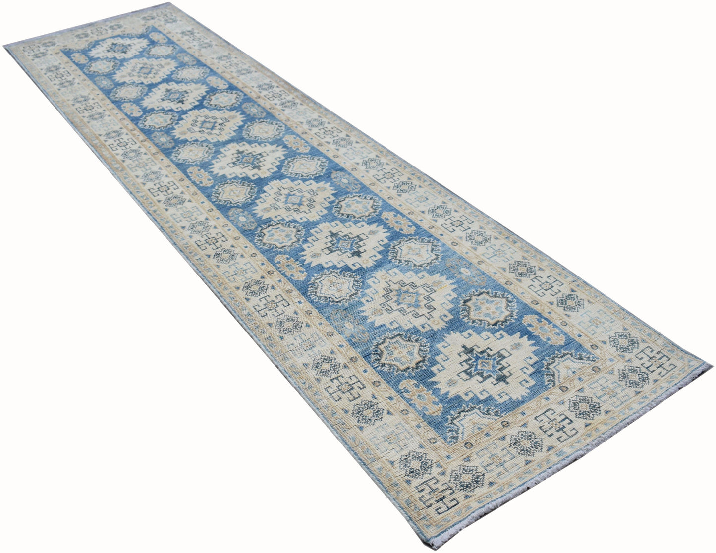 A handmade Afghan Kazakh runner rug featuring a geometric pattern in shades of blue, beige, and grey.