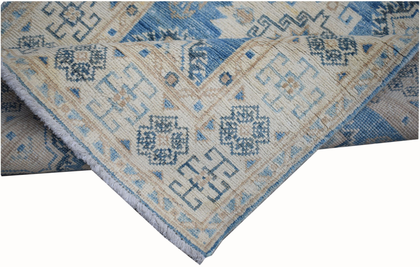 A handmade Afghan Kazakh runner rug featuring a geometric pattern in shades of blue and beige.